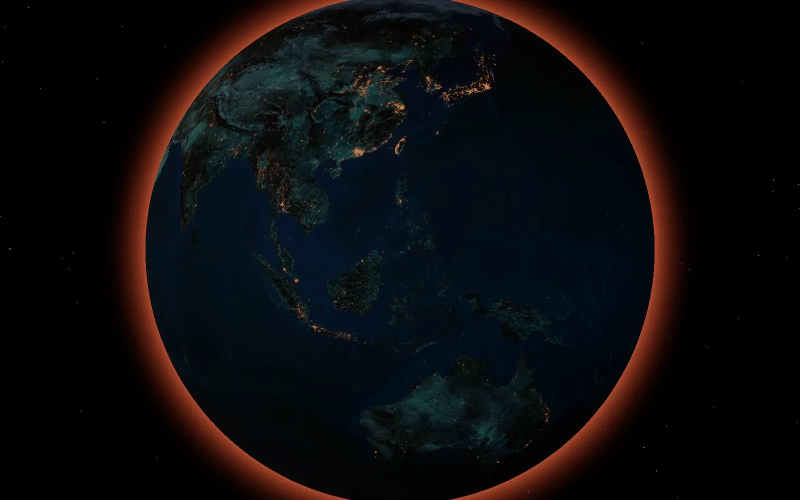 A night view of Earth, its city lights burning against the dark